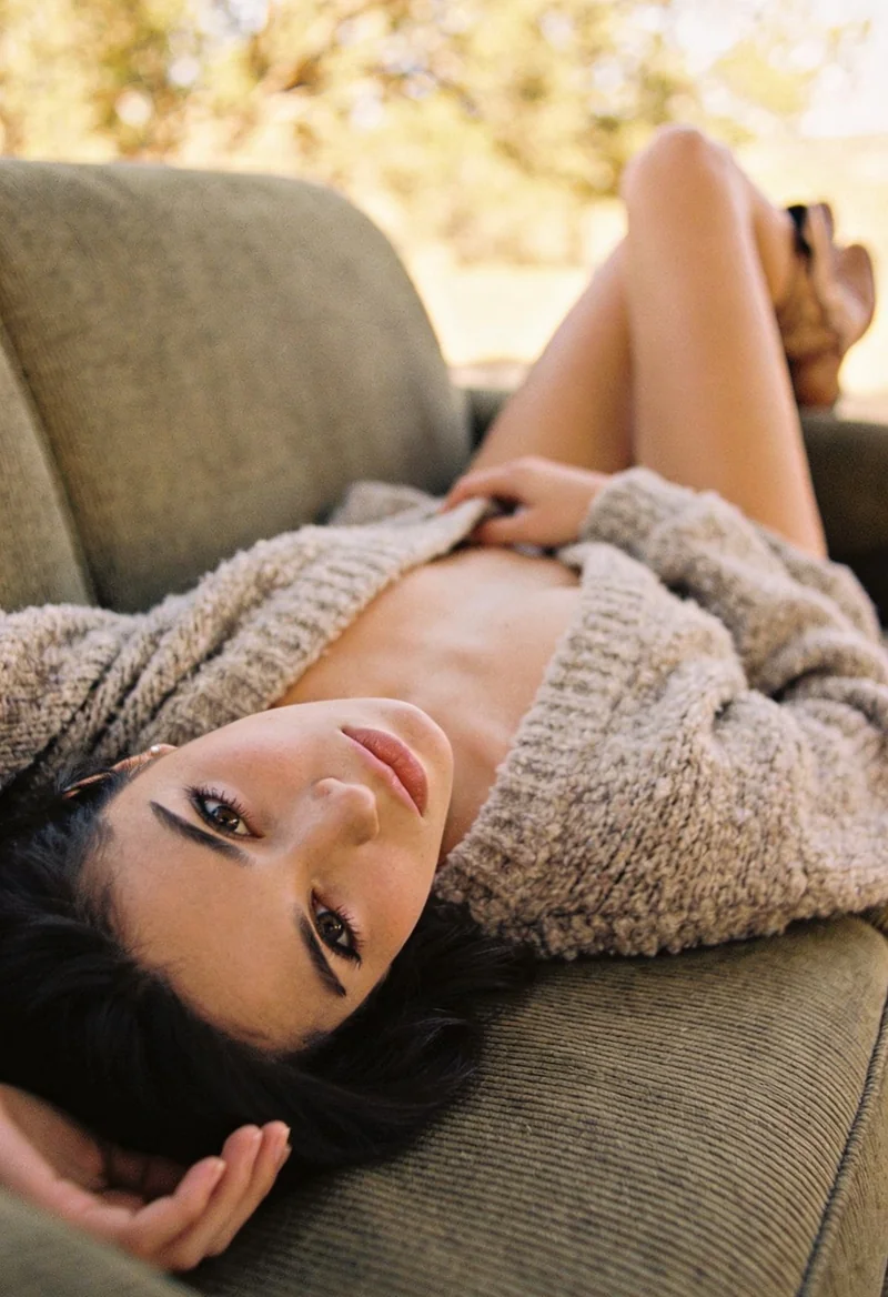 AI-generated woman relaxing on a cozy couch